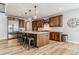 Spacious kitchen boasts wood cabinets, stainless appliances, island with seating, and stylish pendant lighting at 5411 Edenborn Way, Castle Rock, CO 80104