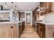 Modern kitchen with stainless appliances, wood cabinets, a spacious island, and sleek design elements at 5411 Edenborn Way, Castle Rock, CO 80104