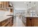 Well-equipped kitchen with stainless appliances, wood cabinetry, and a view to an adjacent dining area at 5411 Edenborn Way, Castle Rock, CO 80104