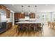 Gourmet kitchen featuring stainless steel appliances, custom cabinets, a large island, and stylish pendant lighting at 5411 Edenborn Way, Castle Rock, CO 80104