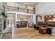 Open floor plan featuring soaring ceilings, stone fireplace, wood floors, and seamless flow to dining and kitchen at 5411 Edenborn Way, Castle Rock, CO 80104