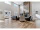 Bright living room features soaring ceilings, wood floors, stone fireplace and updated furniture at 5411 Edenborn Way, Castle Rock, CO 80104