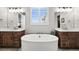 Luxurious main bathroom with dual vanities, a standalone soaking tub, and elegant fixtures at 5411 Edenborn Way, Castle Rock, CO 80104