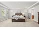 Relaxing main bedroom featuring tray ceilings, neutral decor, a walk-in closet, and an en-suite bathroom at 5411 Edenborn Way, Castle Rock, CO 80104
