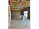 Unfinished kitchen area with exposed framing, wooden studs and a sliding door to the backyard at 664 Deer Park, Watkins, CO 80137