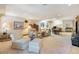 Large finished basement features a variety of seating arrangements on a neutral color palette at 9873 Greensview Cir, Lone Tree, CO 80124