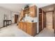 Finished basement features a built-in bar area with wood cabinets, wine rack, sink, and easy access to the stairs and a bathroom at 9873 Greensview Cir, Lone Tree, CO 80124