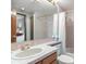 Bathroom featuring a bathtub and shower combo, vanity with sink and tile surround, plus an adjoining bedroom at 9873 Greensview Cir, Lone Tree, CO 80124