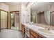 Classic bathroom features dual sinks, ample counter space, and a separate bath and toilet area at 9873 Greensview Cir, Lone Tree, CO 80124