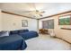 Bright bedroom featuring a ceiling fan, large window, and a cozy reading nook with a desk at 9873 Greensview Cir, Lone Tree, CO 80124