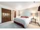 Charming bedroom with carpet, including closet, and a bed adorned with pillows, complimented by a decorative border at 9873 Greensview Cir, Lone Tree, CO 80124