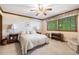 Cozy bedroom with ceiling fan, neutral tones, and natural light from the window at 9873 Greensview Cir, Lone Tree, CO 80124