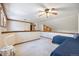 Open bonus room featuring plush carpeting, a ceiling fan, wood railing, and plenty of natural light at 9873 Greensview Cir, Lone Tree, CO 80124