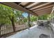 Relaxing covered patio with outdoor seating, concrete flooring and a view of the landscaped backyard and mature trees at 9873 Greensview Cir, Lone Tree, CO 80124