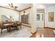 Inviting dining area features a ceiling fan, large window, wood trim and access to the foyer at 9873 Greensview Cir, Lone Tree, CO 80124