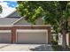 Charming townhome featuring a two-car garage and nicely landscaped front yard at 9873 Greensview Cir, Lone Tree, CO 80124