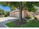 Brick townhome with attached two-car garage, mature shade tree, nice landscaping, and driveway at 9873 Greensview Cir, Lone Tree, CO 80124