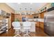 Well-maintained kitchen with wood cabinets, pendant lights, tile countertops and stainless steel appliances at 9873 Greensview Cir, Lone Tree, CO 80124