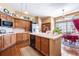 Traditional kitchen features wood cabinets, tiled countertops, and an eat-in breakfast area at 9873 Greensview Cir, Lone Tree, CO 80124