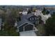 Aerial view of home with a three-car garage, lush landscaping, and surrounding neighborhood at 1521 Redtail Ct, Longmont, CO 80504