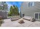 Backyard patio featuring a fire pit, outdoor seating, and shade trees at 1521 Redtail Ct, Longmont, CO 80504