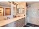 Beautiful bathroom featuring double vanity and tiled walk-in shower with glass door at 1521 Redtail Ct, Longmont, CO 80504