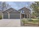 Charming two-story home featuring a three car garage, well-maintained lawn, and decorative trees in a Gathering-friendly neighborhood at 1521 Redtail Ct, Longmont, CO 80504