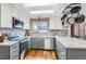 Modern kitchen featuring stone countertops, stainless steel appliances, a window and lots of cabinet space at 1521 Redtail Ct, Longmont, CO 80504