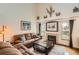 Another view of the comfortable living room with a fireplace, hardwood floors, and great natural light at 1521 Redtail Ct, Longmont, CO 80504