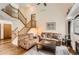 Spacious living room with hardwood floors, a staircase and comfortable seating, perfect for relaxation at 1521 Redtail Ct, Longmont, CO 80504