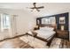 Main bedroom featuring a vaulted ceiling, hardwood floors, windows, and a comfortable bed with side tables at 1521 Redtail Ct, Longmont, CO 80504