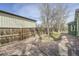 Landscaped backyard with a stone patio, a grass area, a wooden fence, and some young trees at 6000 W 29Th Ave, Denver, CO 80214