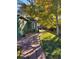 A stone pathway leads through the backyard with mature trees and a seating area at 6000 W 29Th Ave, Denver, CO 80214
