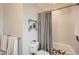 Updated bathroom featuring a shower-tub combination, white subway tiles, and decorative floating shelves at 6000 W 29Th Ave, Denver, CO 80214