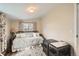 Cozy bedroom featuring a daybed with decorative pillows and curtains, and a dog crate at 6000 W 29Th Ave, Denver, CO 80214