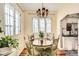 Cozy dining area featuring a round wood table with vintage chandelier and bright natural light at 6000 W 29Th Ave, Denver, CO 80214