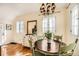 Charming dining room with a round table, light green chairs, and a vintage white dresser at 6000 W 29Th Ave, Denver, CO 80214