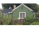 A well-maintained green home with a stone chimney and classic architecture at 6000 W 29Th Ave, Denver, CO 80214