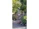 Exterior view of a green house behind a wooden fence and a 6000 address marker at 6000 W 29Th Ave, Denver, CO 80214