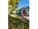 Charming green home with a bright red front door and stone pathway at 6000 W 29Th Ave, Denver, CO 80214