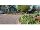 Landscaped front yard with flowering irises and a charming green home in the background at 6000 W 29Th Ave, Denver, CO 80214