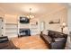 Living room with built-in shelving, fireplace, hardwood floors and leather sofas at 6000 W 29Th Ave, Denver, CO 80214