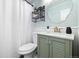 Charming bathroom featuring a stylish vanity with a green cabinet and a unique decorative mirror at 4196 Chase St, Denver, CO 80212