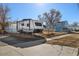 Exterior view of a fenced property with a camper parked on the gravel in front of the blue house at 4196 Chase St, Denver, CO 80212