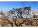 Classic home with a welcoming front porch, charming architectural details, and mature landscaping at 4196 Chase St, Denver, CO 80212