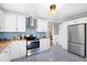 Modern kitchen with white cabinets, butcher block countertops, stainless steel appliances, and stylish flooring at 4196 Chase St, Denver, CO 80212