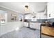 Bright kitchen features white cabinetry, butcher block counters, stainless appliances, and decorative blue tile accents at 4196 Chase St, Denver, CO 80212