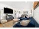 Inviting living room boasts a comfortable blue sectional sofa, stylish decor, and hardwood floors at 4196 Chase St, Denver, CO 80212