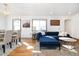 Living and dining areas offer hardwood floors, bright windows, and a comfortable sectional sofa at 4196 Chase St, Denver, CO 80212
