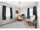 Inviting office features warm hardwood floors, a comfortable chair and dark curtains perfect for a workspace at 4196 Chase St, Denver, CO 80212